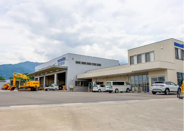 建設機械が並ぶ事業所と整備工場